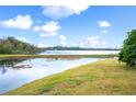 Scenic lake view with blue skies and puffy white clouds, highlighting the serene backyard at 4048 Windchime Ln, Lakeland, FL 33811