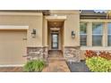 Inviting entryway with stone accents and elegant lantern lighting at 4224 Prima Lago Dr, Lakeland, FL 33810