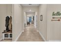 Open concept hallway with tile floors and built-in bench seating at 4224 Prima Lago Dr, Lakeland, FL 33810