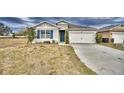 One story home with gray siding, blue shutters, and a two-car garage at 442 Jacks Way, Davenport, FL 33837