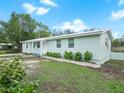 Newly renovated light teal home with a landscaped yard at 4517 Oak St, Lakeland, FL 33813