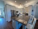 Modern kitchen with stainless steel appliances and granite countertops at 593 Meandering Way, Polk City, FL 33868