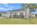 White house with gray architectural details, landscaping, and a driveway at 6111 Morningview Dr, Lakeland, FL 33813