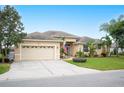 Single-Gathering home with a spacious driveway and American flag at 6550 Evergreen Park Dr, Lakeland, FL 33813