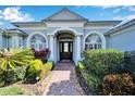 House entrance with a double door and a brick pathway at 7068 Island Lake Ln, Lakeland, FL 33813