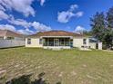 Spacious backyard with screened patio and large grassy area at 8 Sawfish Ln, Kissimmee, FL 34759