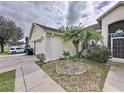 Home's exterior showcasing a side view of garage and landscaping at 8 Sawfish Ln, Kissimmee, FL 34759