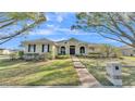 Single-story house with a front walkway and well-manicured lawn at 875 Hanover Way, Lakeland, FL 33813