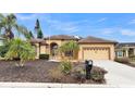 Single-story home with a two-car garage and landscaped yard at 6714 Highlands Creek Loop, Lakeland, FL 33813