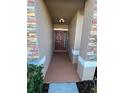 Covered entryway with a terracotta-colored floor and a brown door at 1038 Suffragette Cir, Haines City, FL 33844