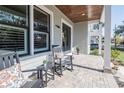 Cozy front porch with rocking chairs, table, and a view of the neighborhood at 127 W Belmar St, Lakeland, FL 33803