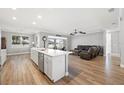 Modern kitchen with island, stainless steel appliances, and hardwood floors at 1427 Magnolia Ln, Auburndale, FL 33823