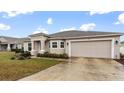 House exterior showcasing a beige facade and spacious driveway at 155 Kissengen Park Blvd, Bartow, FL 33830