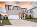 Two-story house with a two-car garage and landscaped lawn at 1726 Eagle Hammock Blvd, Eagle Lake, FL 33839