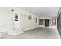 Covered carport with screened enclosure and concrete flooring at 1801 Quail Hill Dr, Lakeland, FL 33810