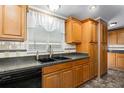 Spacious kitchen with wood cabinets, dark countertops, and black appliances at 1801 Quail Hill Dr, Lakeland, FL 33810