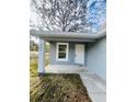 Charming front porch with white door and gray siding at 2006 Kendrick Ln, Lakeland, FL 33805