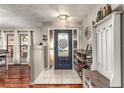 Inviting entryway with a blue door and built-in storage at 2070 Katie Ct, Winter Haven, FL 33884