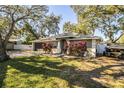 Single story home with a large front yard, mature trees, and a neutral exterior at 2227 Howard West Ave, Winter Haven, FL 33880