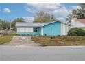 Charming light blue house with a yellow garage, curb appeal at 2304 Honey Dr, Lakeland, FL 33801