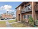 Brick townhouse with balcony and parking lot view at 2369 Tom Jones St # 8, Orlando, FL 32839