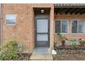 Gray front door with storm door, brick facade at 2369 Tom Jones St # 8, Orlando, FL 32839