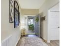 Inviting foyer boasts decor, neutral paint, wood floors and ample natural light at 2610 San Marco Way, Winter Haven, FL 33884