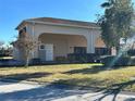 Front view of tan house with covered entryway at 265 Laynewade Rd, Polk City, FL 33868