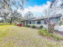 Side view of a ranch home with landscaping at 2720 Ewell Rd, Lakeland, FL 33811