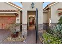 Stone and stucco exterior with an open courtyard entry at 2961 Sanctuary Cir, Lakeland, FL 33803