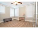 Bright bedroom with light wood floors and window blinds at 306 Avenue C Ne, Winter Haven, FL 33881