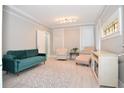 Living room features a green velvet couch and chaise lounge at 306 Avenue C Ne, Winter Haven, FL 33881