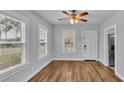 Dining area with hardwood floors, white door and ceiling fan at 3220 Clubhouse Rd, Lakeland, FL 33812