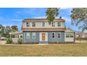 Renovated home with gray siding, brown roof and landscaping at 3220 Clubhouse Rd, Lakeland, FL 33812