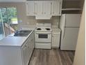 Efficient kitchen featuring white cabinets and modern appliances at 3472 Avenue V Nw, Winter Haven, FL 33881