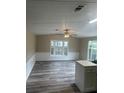 Bright living room with large windows and laminate flooring at 3472 Avenue V Nw, Winter Haven, FL 33881