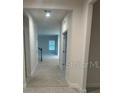 Bright hallway with light-colored flooring and access to other rooms at 357 Siesta Vista Ct, Davenport, FL 33896