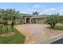 House exterior with palm trees and paver driveway at 3604 Frentress Dr, Lakeland, FL 33812