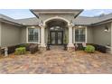 Front entrance with double doors and stone columns at 3604 Frentress Dr, Lakeland, FL 33812