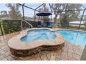 Relaxing pool and spa with a screened enclosure and patio furniture at 3604 Frentress Dr, Lakeland, FL 33812