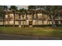 Condo building showcasing screened balconies and a well-maintained lawn at 362 Enclave Dr, Lakeland, FL 33803