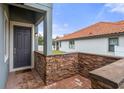 Front entry with dark gray door and brick wall at 4108 Solamor St, Lakeland, FL 33810