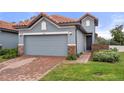 Gray house with tile roof and brick walkway at 4108 Solamor St, Lakeland, FL 33810