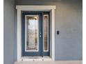 Modern front door with glass panels and a doorbell at 4185 Shearwater St, Lakeland, FL 33811