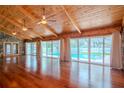 Spacious living area with hardwood floors, high ceilings and pool view at 4225 Shadow Wood Ct, Winter Haven, FL 33880