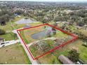 Aerial view showing home's location on a large lot with a pond at 4312 Glenview Dr, Lakeland, FL 33810