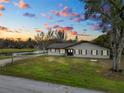 Ranch style home with a large backyard and water view at sunset at 4312 Glenview Dr, Lakeland, FL 33810