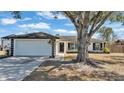 Charming single story home with attached garage and mature landscaping at 5125 Pheasant Dr, Mulberry, FL 33860