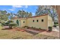 Side view of the house with a brick pathway at 513 E Highland Dr, Lakeland, FL 33813