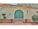 Charming teal front door entry to a remodeled home at 513 E Highland Dr, Lakeland, FL 33813